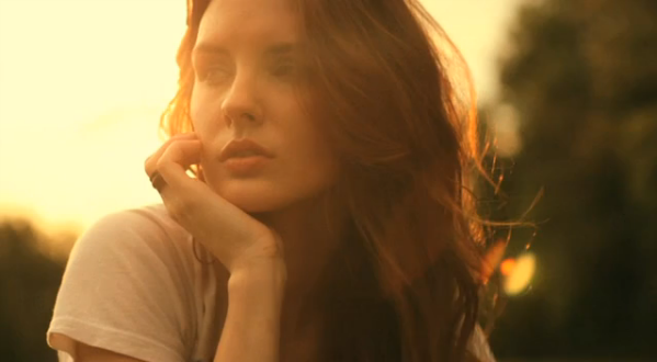 Sunset portrait of the model resting her face on one hand