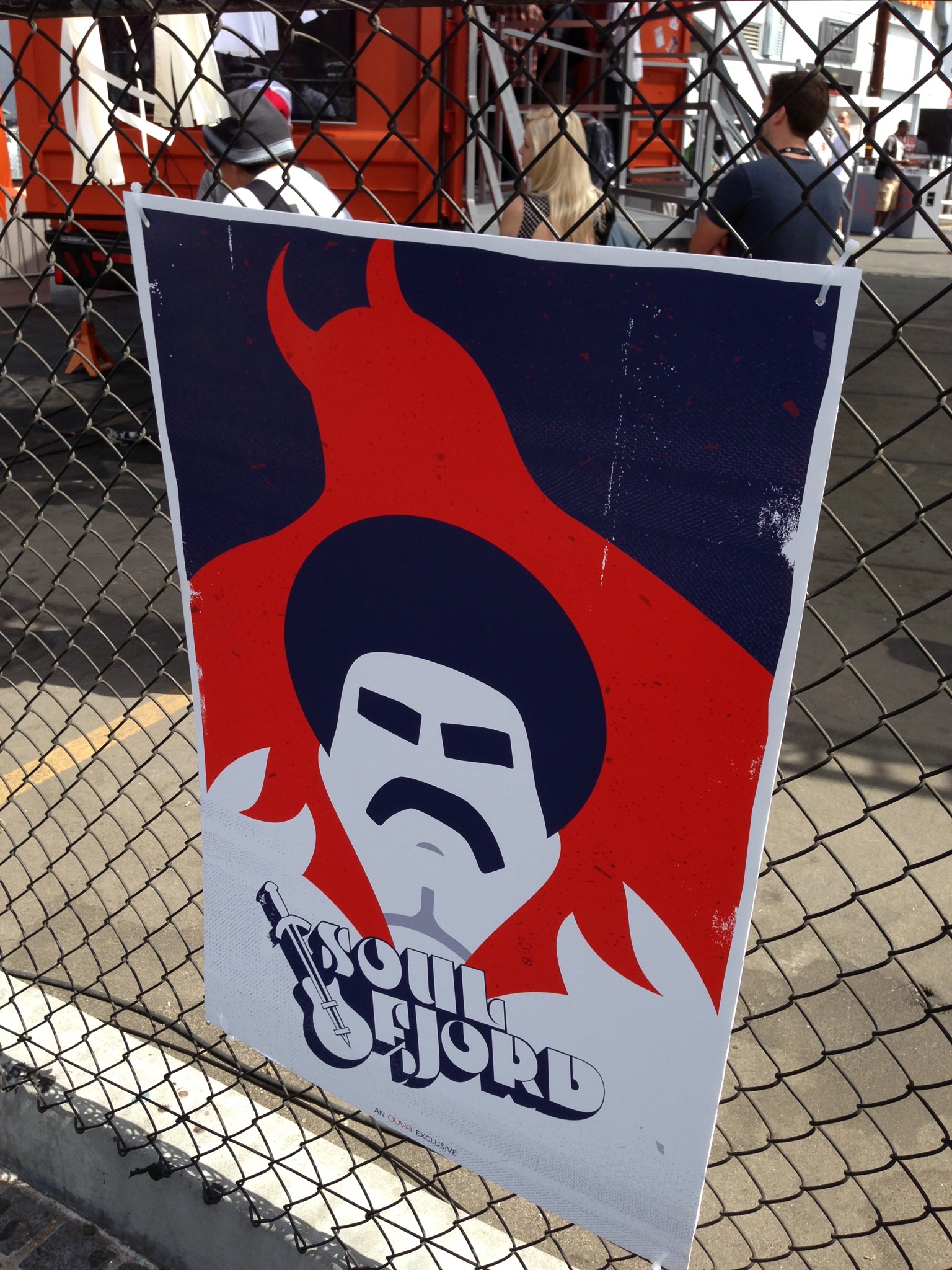 Soul Fjord poster zip-tied to the chain-link fence outside E3